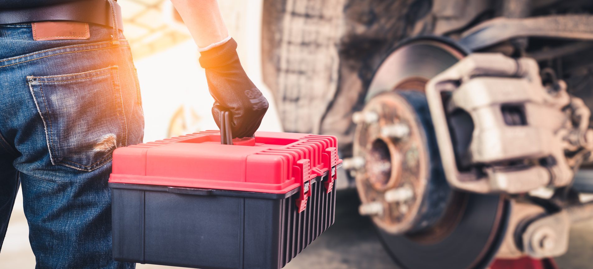 A mobile mechanic working on a car on-site